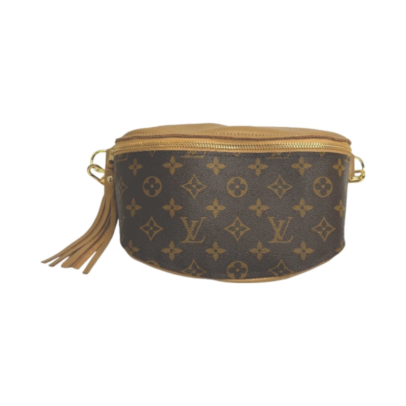 The Faire Upcycled Belt Bag features brown and tan canvas with a gold zipper, leather tassel, and signature monogram—a chic designer accessory for any collection.