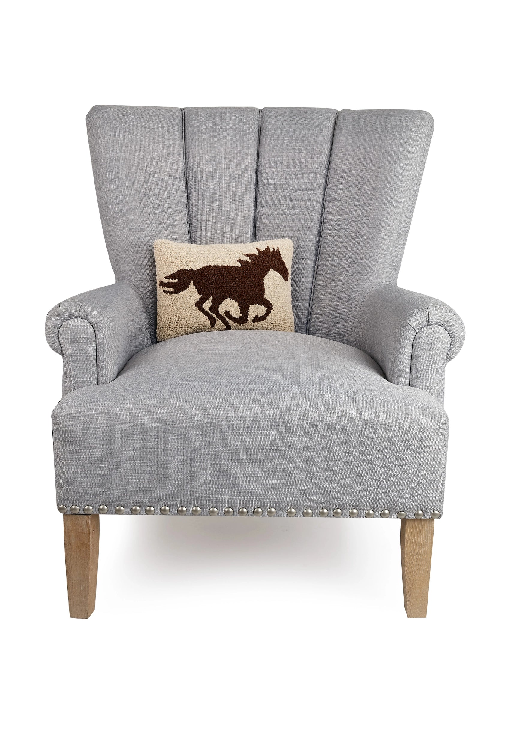 Gray armchair with wood legs, styled with Faire’s wool hooked Racehorse Silhouette Pillow.