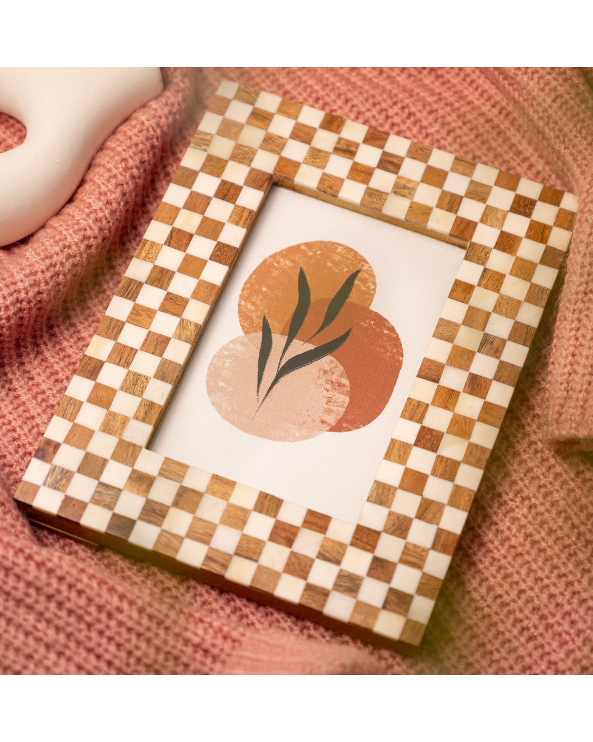 Bone and wood checkered 5x7 frame by Bungalow, displaying abstract art with orange circles and green leaves.