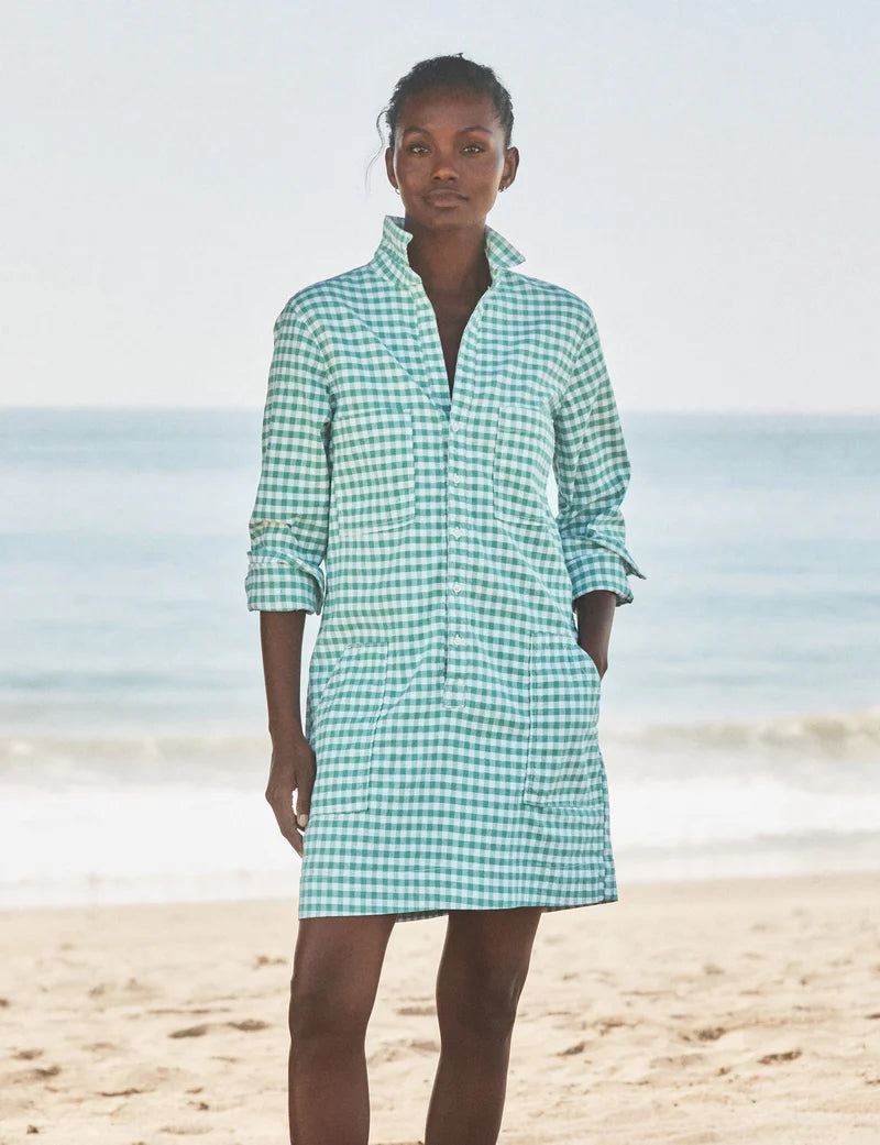 On a sandy beach in Southern Ireland, a woman wears the Frank & Eileen Southern Dress as the ocean and sky provide a scenic backdrop.