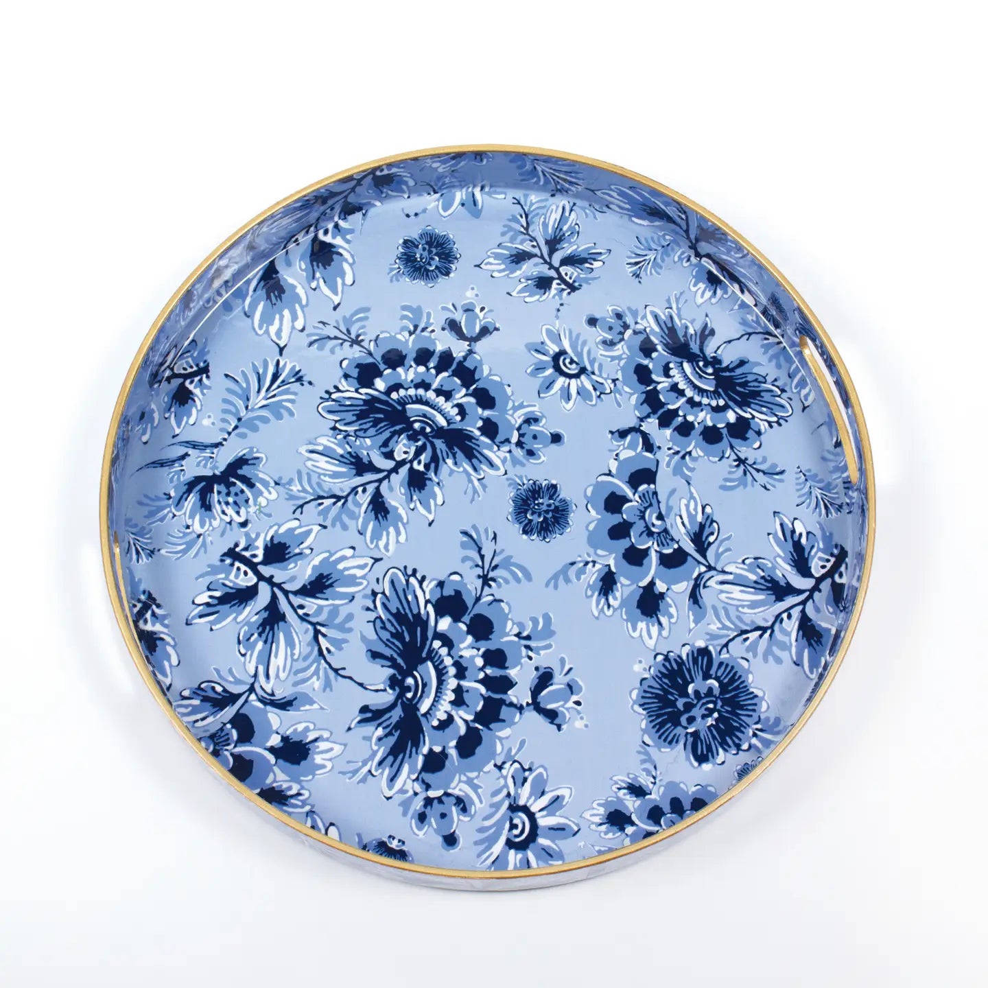 The Blue Floral Round Tray by Faire showcases a vibrant blue floral pattern set against a light blue background, accentuated by an elegant shiny gold rim. The intricately designed flowers provide classic beauty and sophisticated organization, making it perfect for any decor setting.