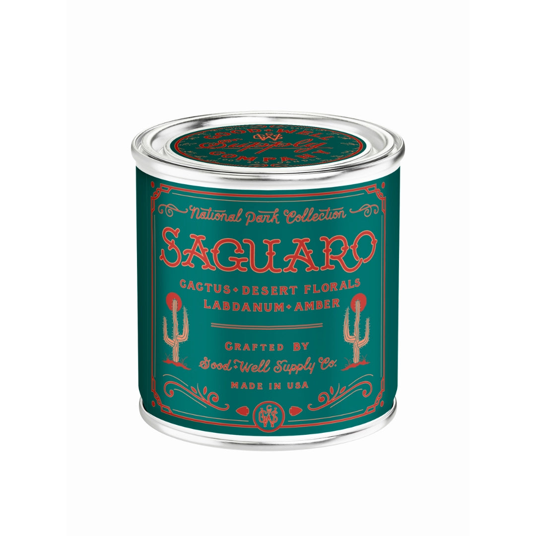 The Saguaro National Park Candle by Faire comes in a green and silver tin with cactus art, featuring scents of cactus, desert florals, labdanum, and amber. Made in the USA.