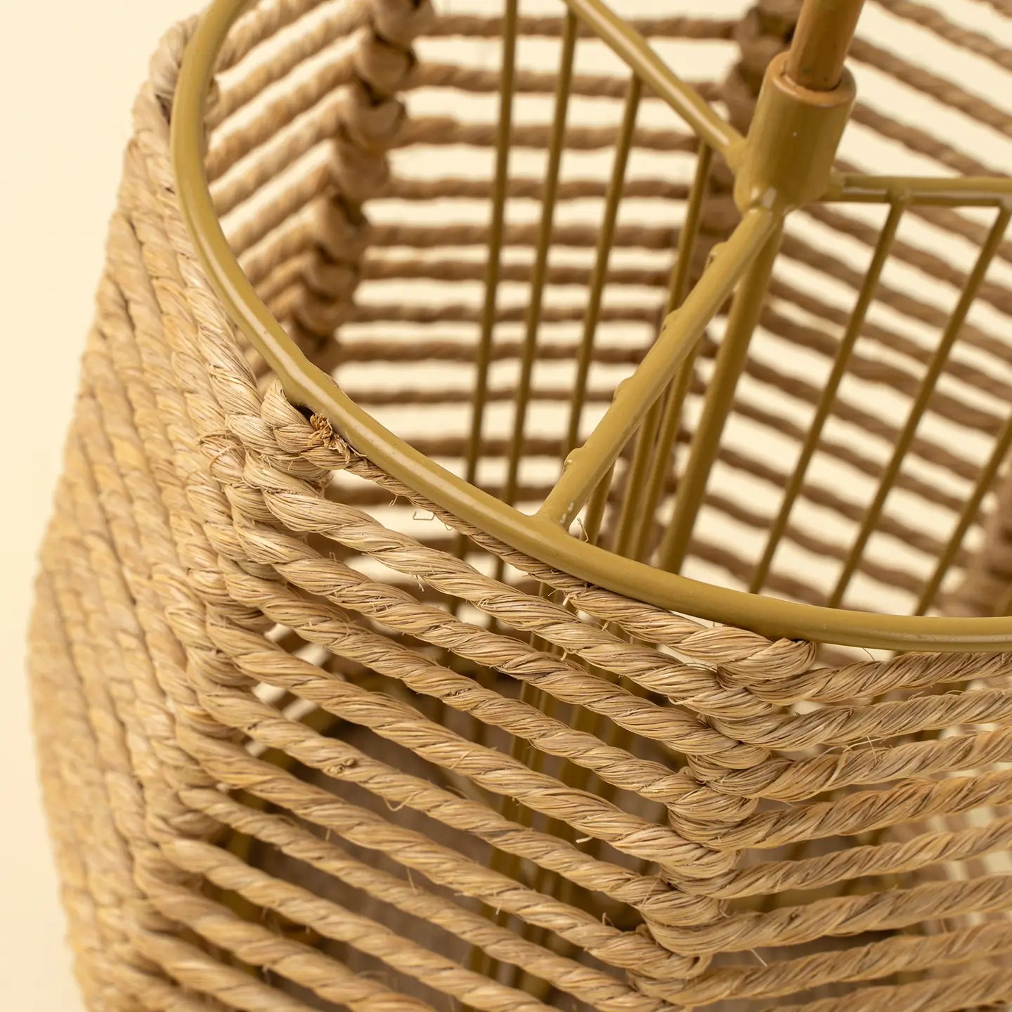 The Indaba Woven Cutlery Holder features a sturdy metal frame and handle, highlighting its intricate handwoven jute pattern and sustainable materials—perfect for organizing your utensils in style.