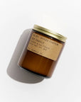 A brown glass jar PFC Candle by Faire with a gold lid casts a shadow. Its kraft label reads "Spiced Pumpkin Soy Candle, 100% soy wax, hand-poured, made in California" on a white background.