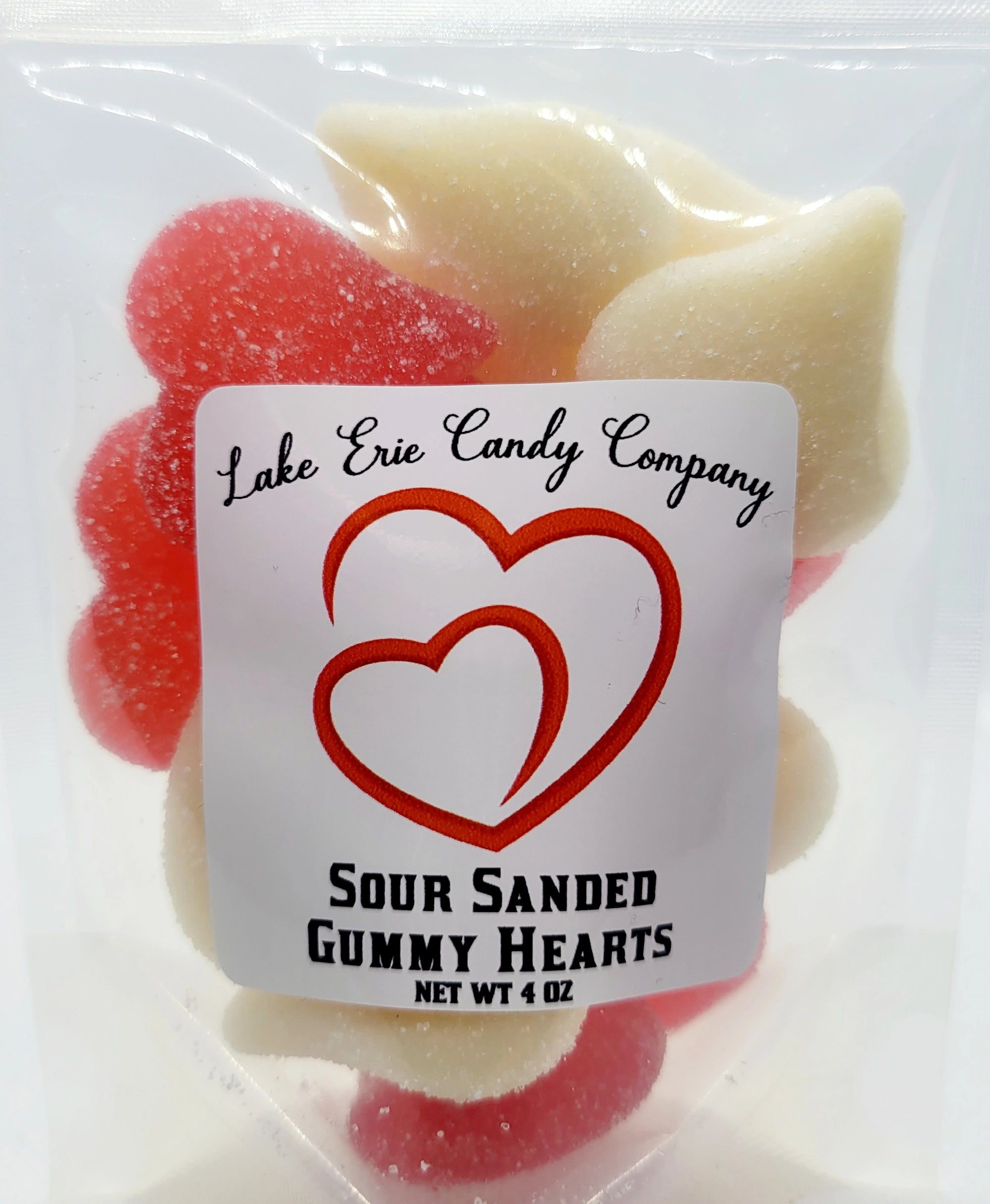 A clear bag of Faire’s Lake Erie Valentine Candy displays red and white heart-shaped gummies. Ideal for Valentine’s Day, the label features two overlapping hearts along with product details.