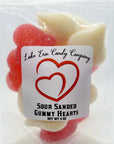 A clear bag of Faire’s Lake Erie Valentine Candy displays red and white heart-shaped gummies. Ideal for Valentine’s Day, the label features two overlapping hearts along with product details.