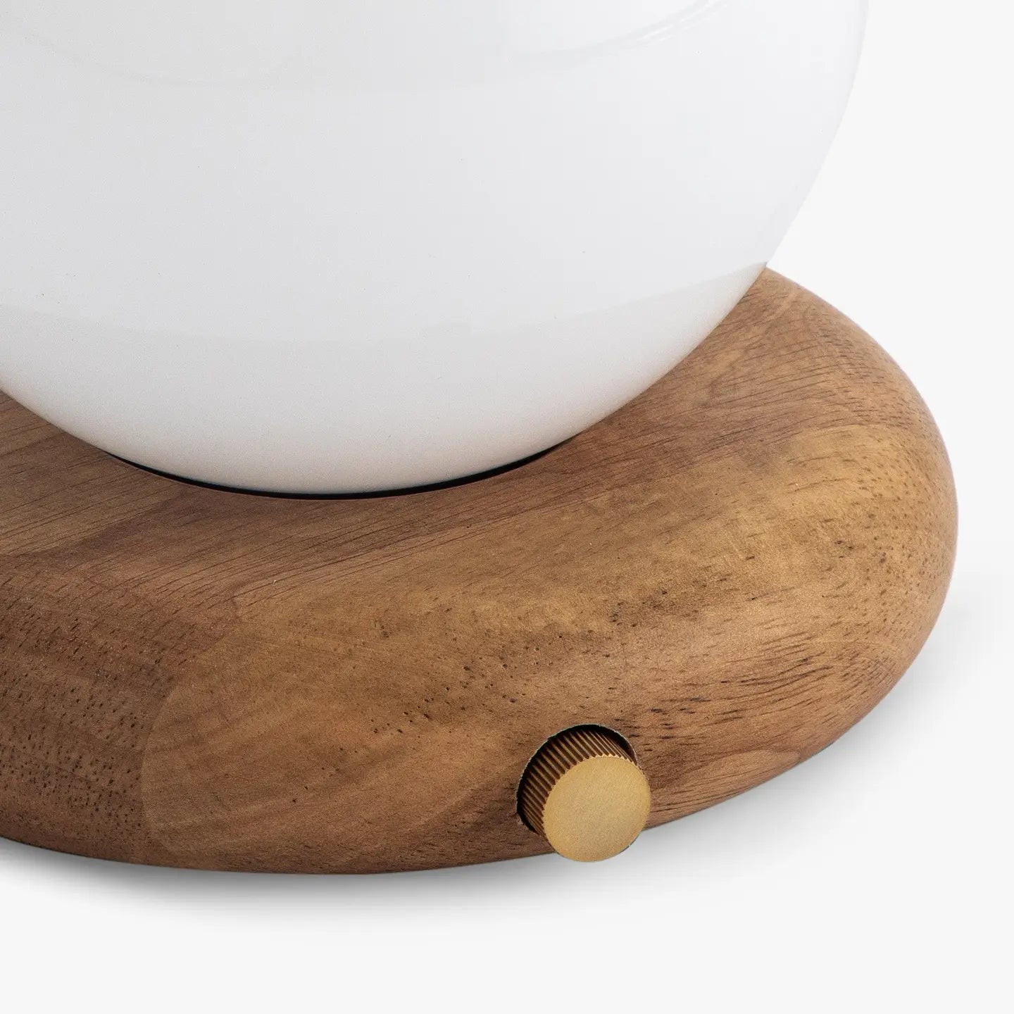 A close-up of the Faire Valencia Portable Light—a round wooden base lamp with a gold knob and white top—set against a plain background.
