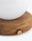 A close-up of the Faire Valencia Portable Light—a round wooden base lamp with a gold knob and white top—set against a plain background.
