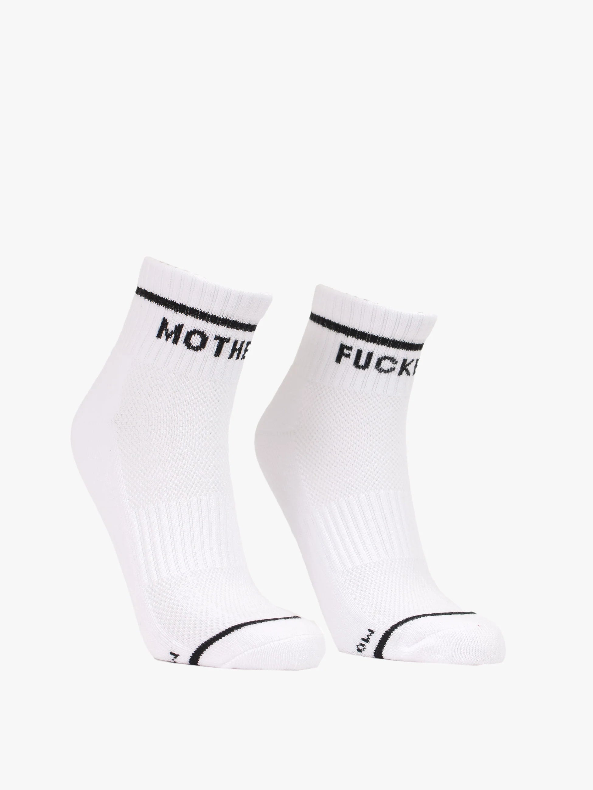 The Baby Steps Ankle socks by Mother feature black and white styling with black trim. "MOTHER" appears on the left sock and "FUCKER" on the right, giving a bold edge to classic tube socks.