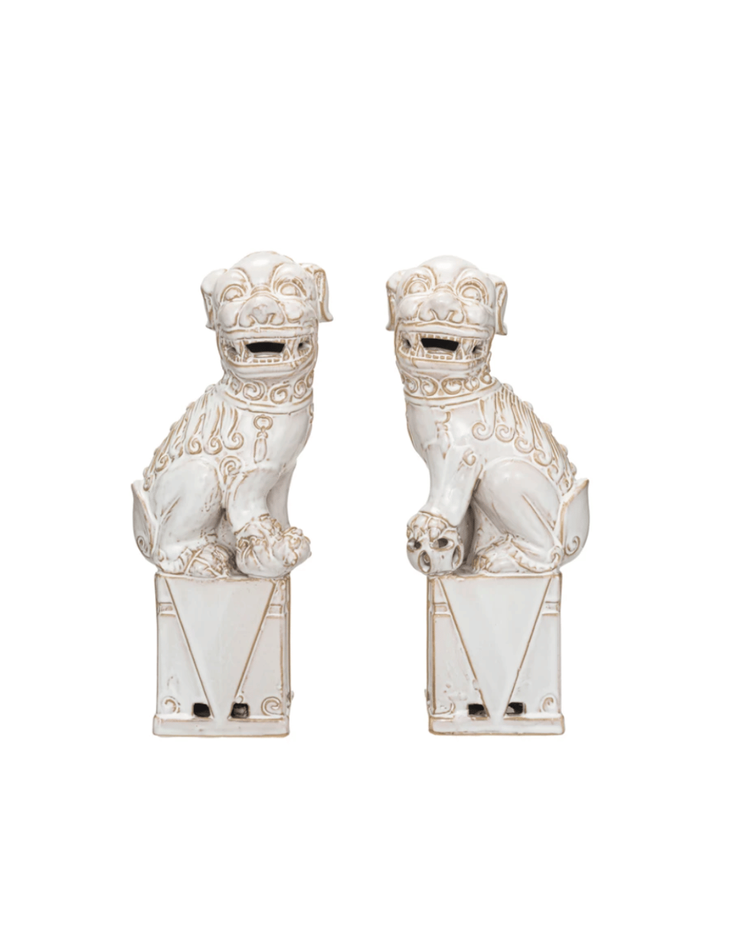 Two white porcelain Creative Co-op Foo Dog Bookends S/2, also known as Foo Dogs, depicted in seated positions on ornate rectangular pedestals at a bungalow in Scottsdale Arizona, facing forward with detailed carvings and embellishments.