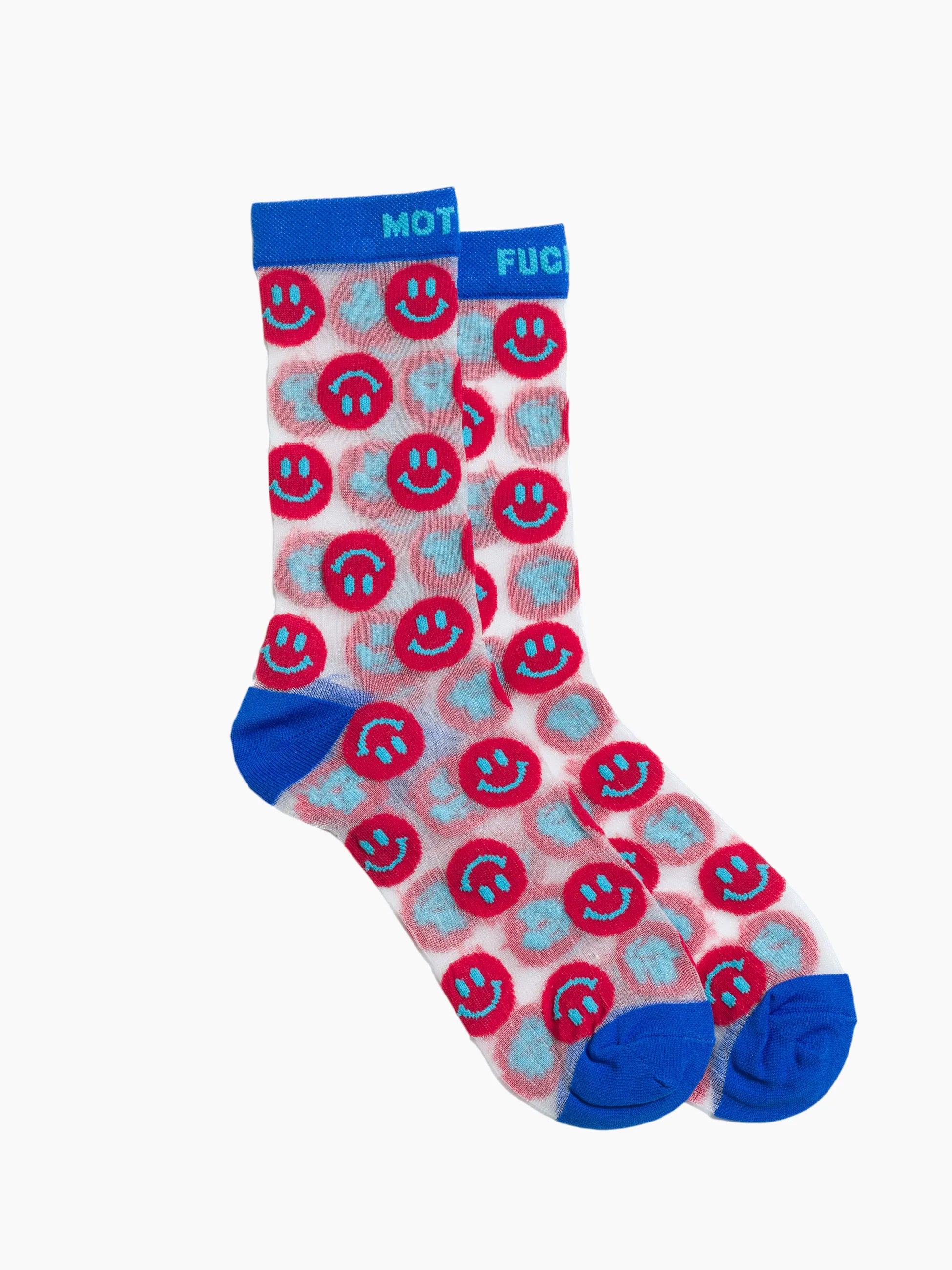 The Step Up Sock by Mother features white tube socks with blue cuffs, heels, and toes, a repeated red smiley face pattern with blue and white accents, black stars on a translucent grey band.