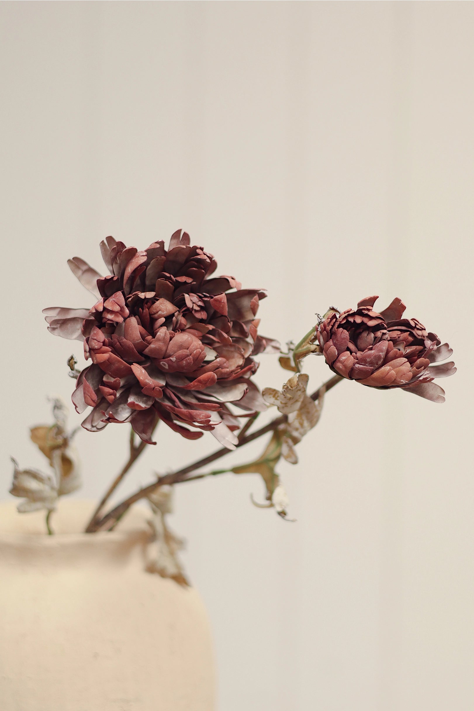 Burgundy Dahlia Spray in vase, by Faire, vibrant artificial floral accent on a light background.