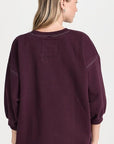 Rachel Comey Fond Sweatshirt in light brown, styled with blue jeans, model shown from the back.