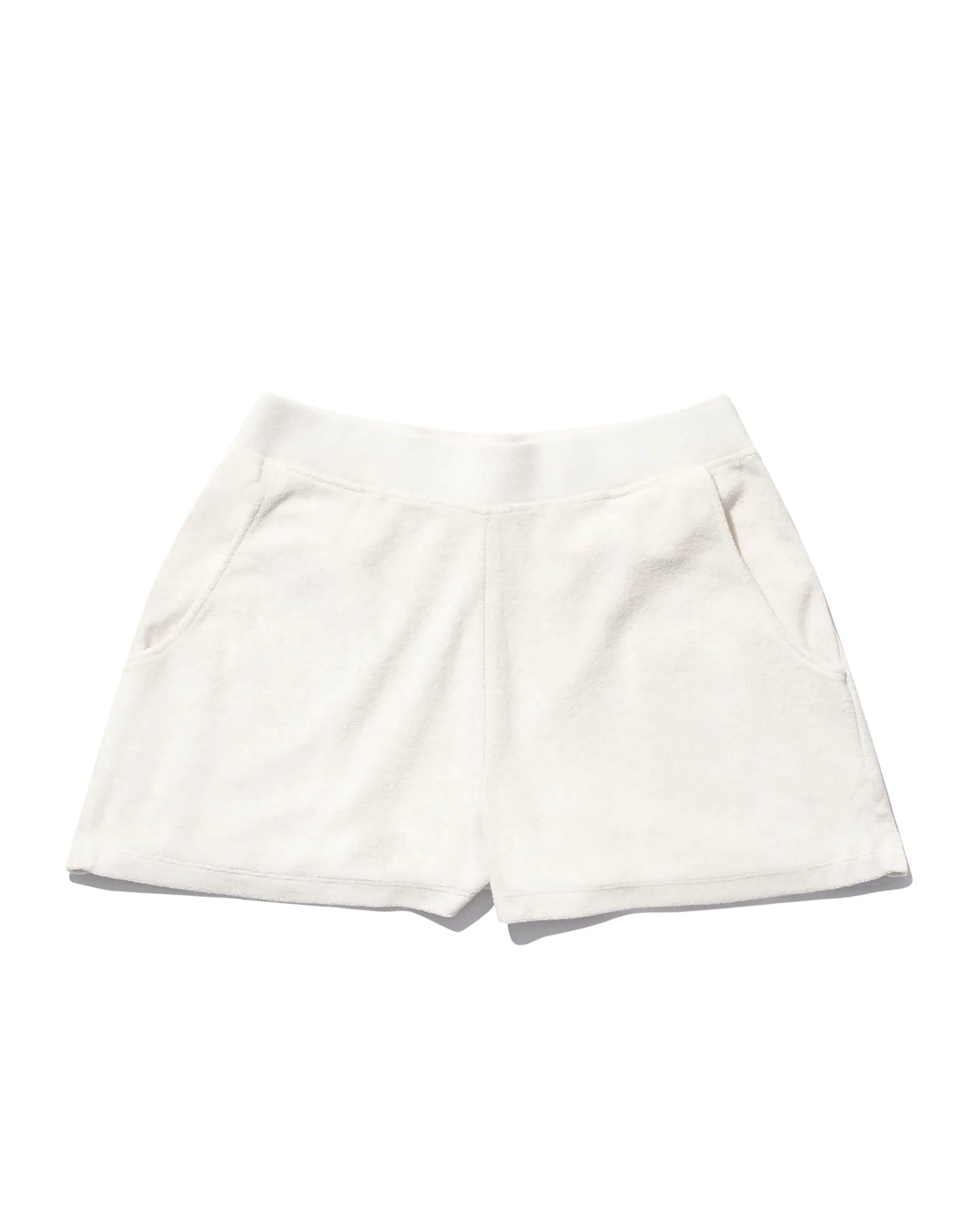 The Terry Venus short by Kule features white cotton-blend terry fabric, an elastic waist, and side pockets, shown laid flat on a white background.