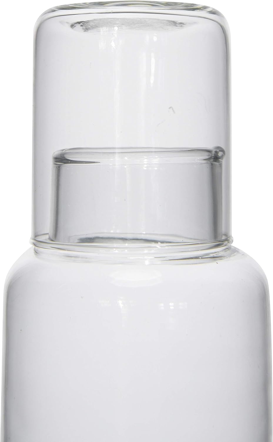 Close-up of the Creative Co-op Decanter With Glass—a clear glass bottle with a matching tumbler lid, showcased on a plain white background; an elegant tableware addition or perfect for picnics.