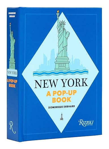 Blue book cover titled "New York Pop UP Book" by Dominique Ehrhard, ideal as a tourist souvenir. It showcases an illustration of the Statue of Liberty on a diamond-shaped background, highlighting New York landmarks, with the Random House logo at the bottom right.