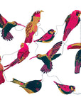 Faire’s Paper Garland/Chains features colorful illustrated tropical birds in pink, yellow, red, green, and black, all strung together for a festive birthday decoration.