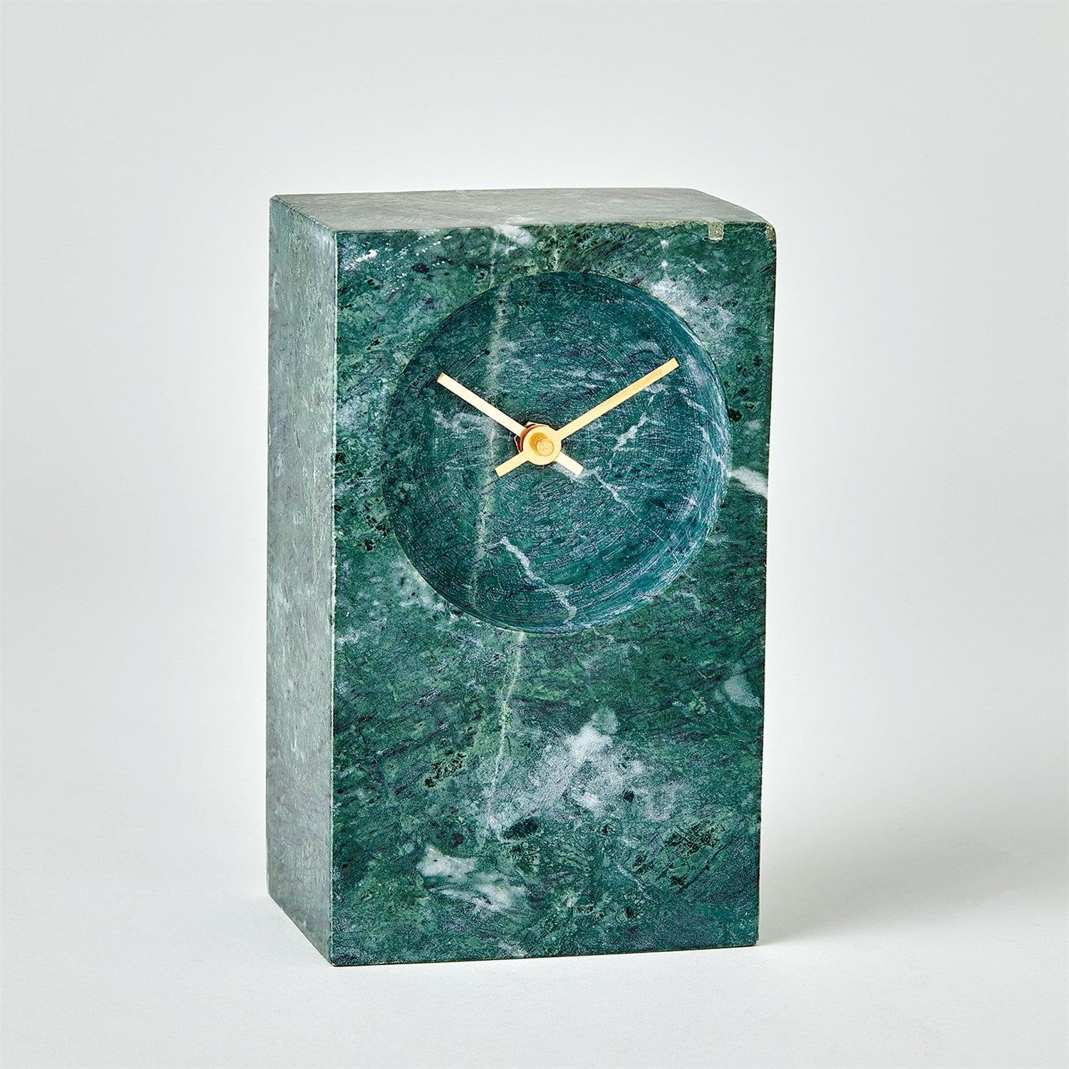 The Marble Tower Clock Green by Global Views is a rectangular clock with a round face in green marble. It features minimalist gold hands, brass accents, and operates on an AA battery. Its sleek, modern design with a smooth, textured finish enhances any space.