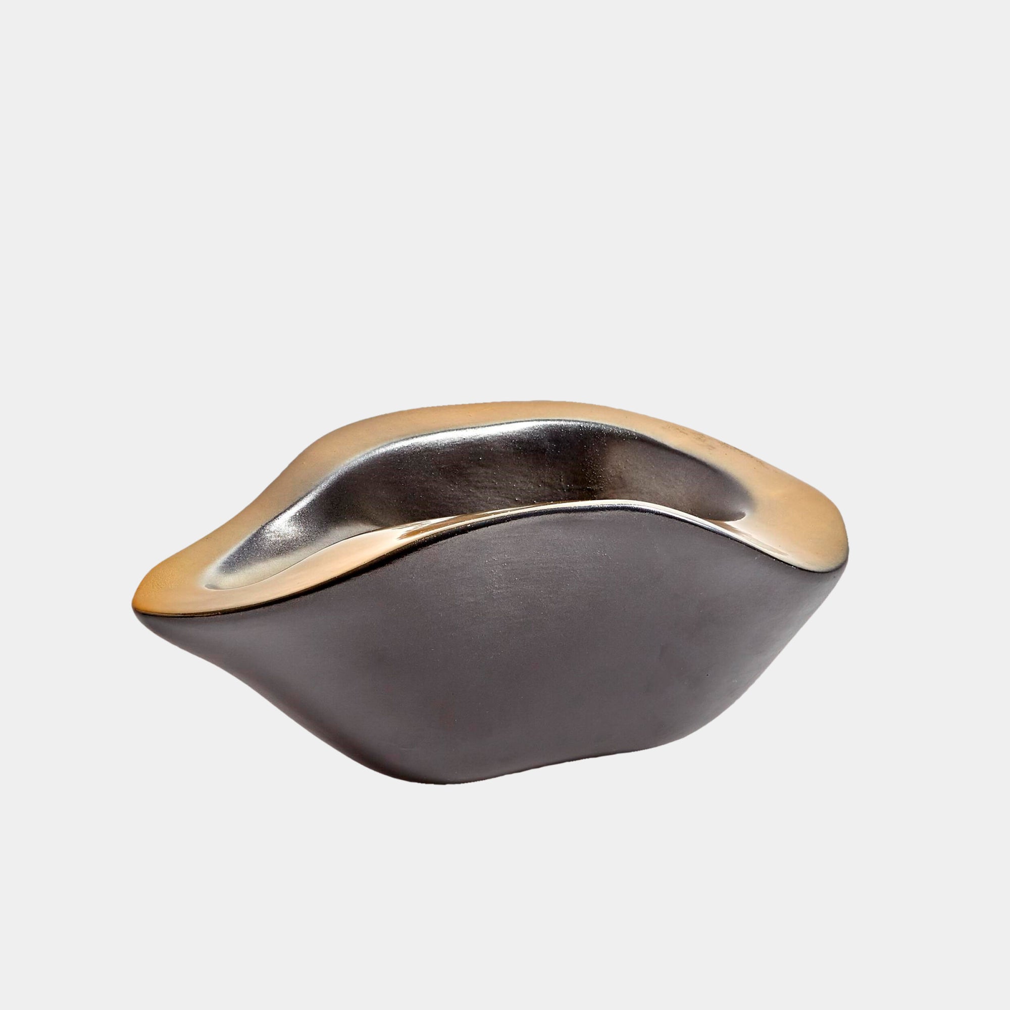 The Global Views Formation Bowl features an organic, metallic design with smooth, undulating edges and a shiny silver and gold finish, displayed against a plain white background.