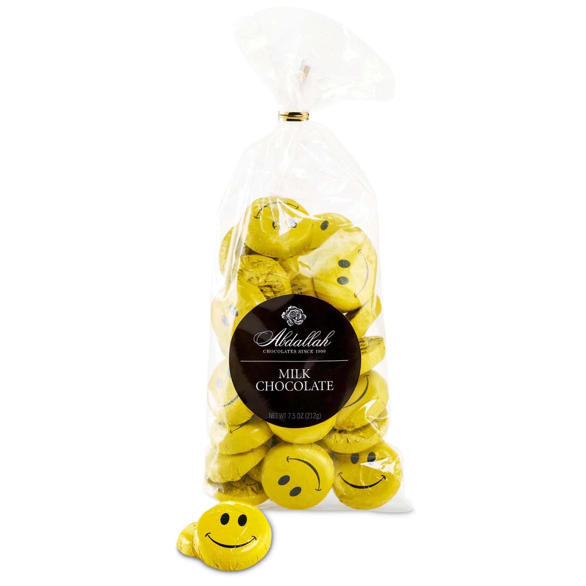 Yellow foil-wrapped chocolates with smiley faces are in a clear plastic bag labeled "Abdallah." The bag specifies "Milk Chocolate Bags," and one solid chocolate is outside the bag.