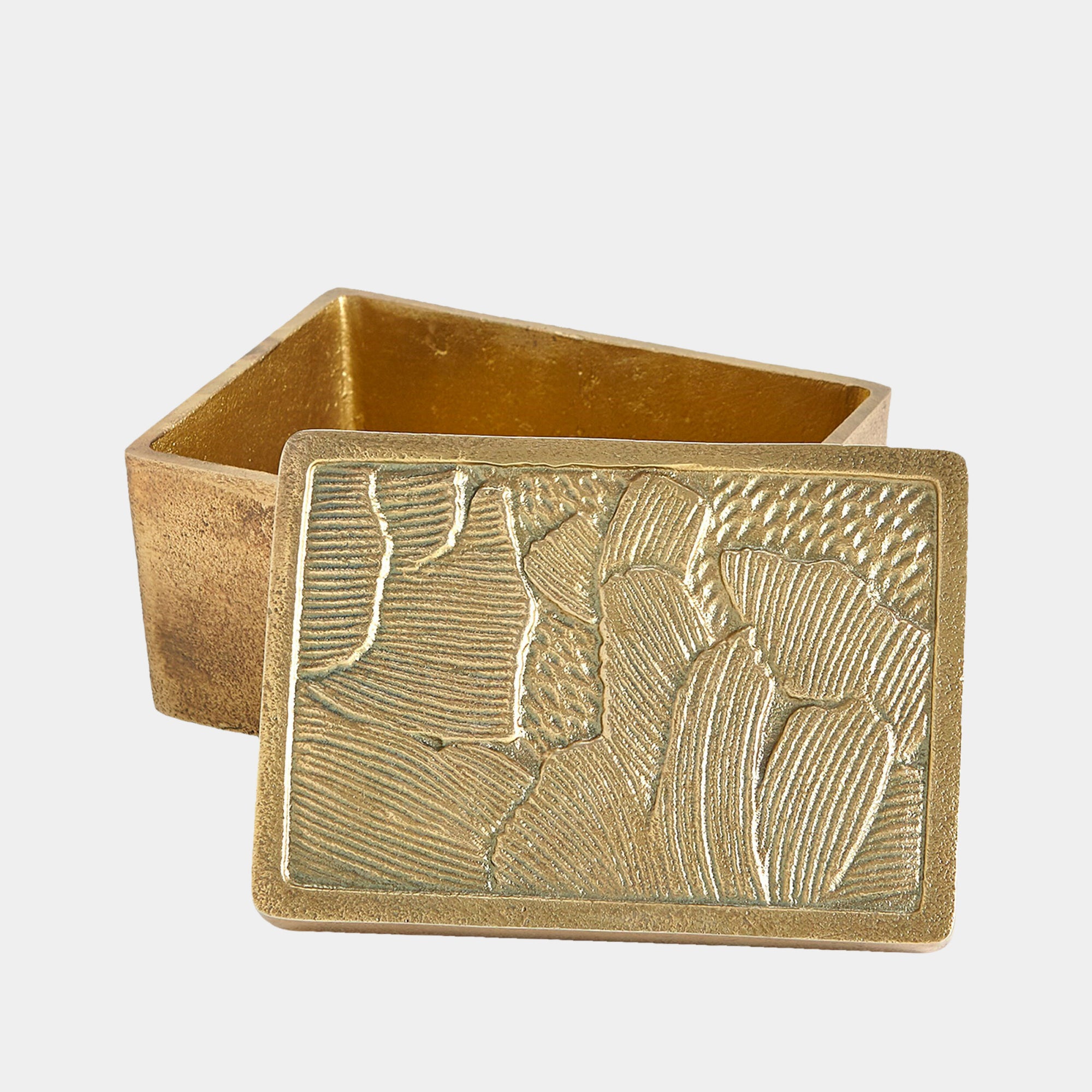 The Flora Box Antique Brass by Global Views is a small, rectangular decorative box with an antique brass textured lid featuring abstract patterns. The lid is slightly open, revealing the empty interior.