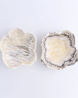 Pair of yellow and white marbled ceramic flower dishes inspired by Faire’s Mexican Onyx Zebra Bowl at Bungalow Furniture.