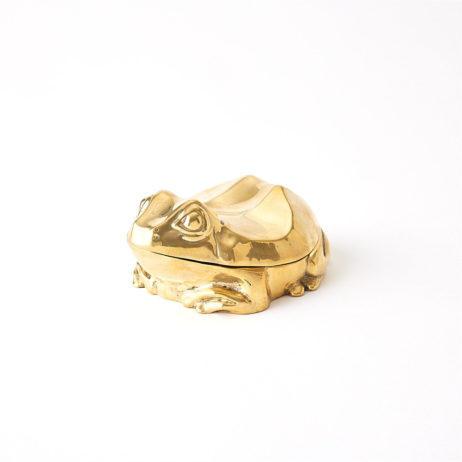 The Solid Brass Frog Box by Global Views, with its shiny golden hue and intricate features, sits elegantly on a plain white background. Its smooth surface and vintage charm make this decorative piece a timeless addition to any collection.
