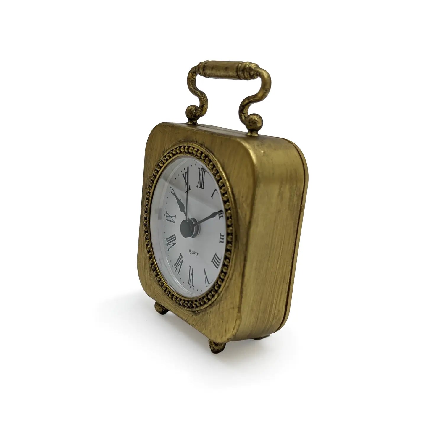 The Zentique Gold Table Clock Pewter features a vintage-inspired gold finish, Roman numerals, decorative handle, and rounded edges on two short legs—an elegant accent to bring timeless charm to any modern decor.