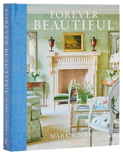 Cover of the book "Forever Beautiful," published by Random House. The image features an elegant living room adorned with a fireplace, decorative objects, and green armchairs. This classic design perfectly encapsulates the essence of American decorating at its best, offering interiors that are both timeless and welcoming.