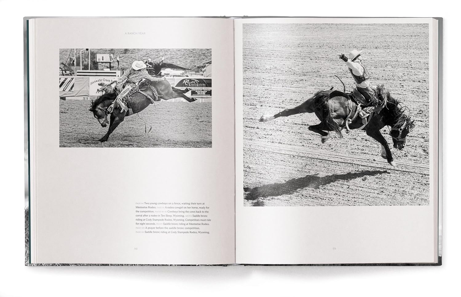 A Ranch Year by Ingram Book Company features cowboy fine art with black-and-white photos of Wyoming ranch life, showing cowboys riding bucking horses—one airborne, another holding tight—in classic rodeo scenes.