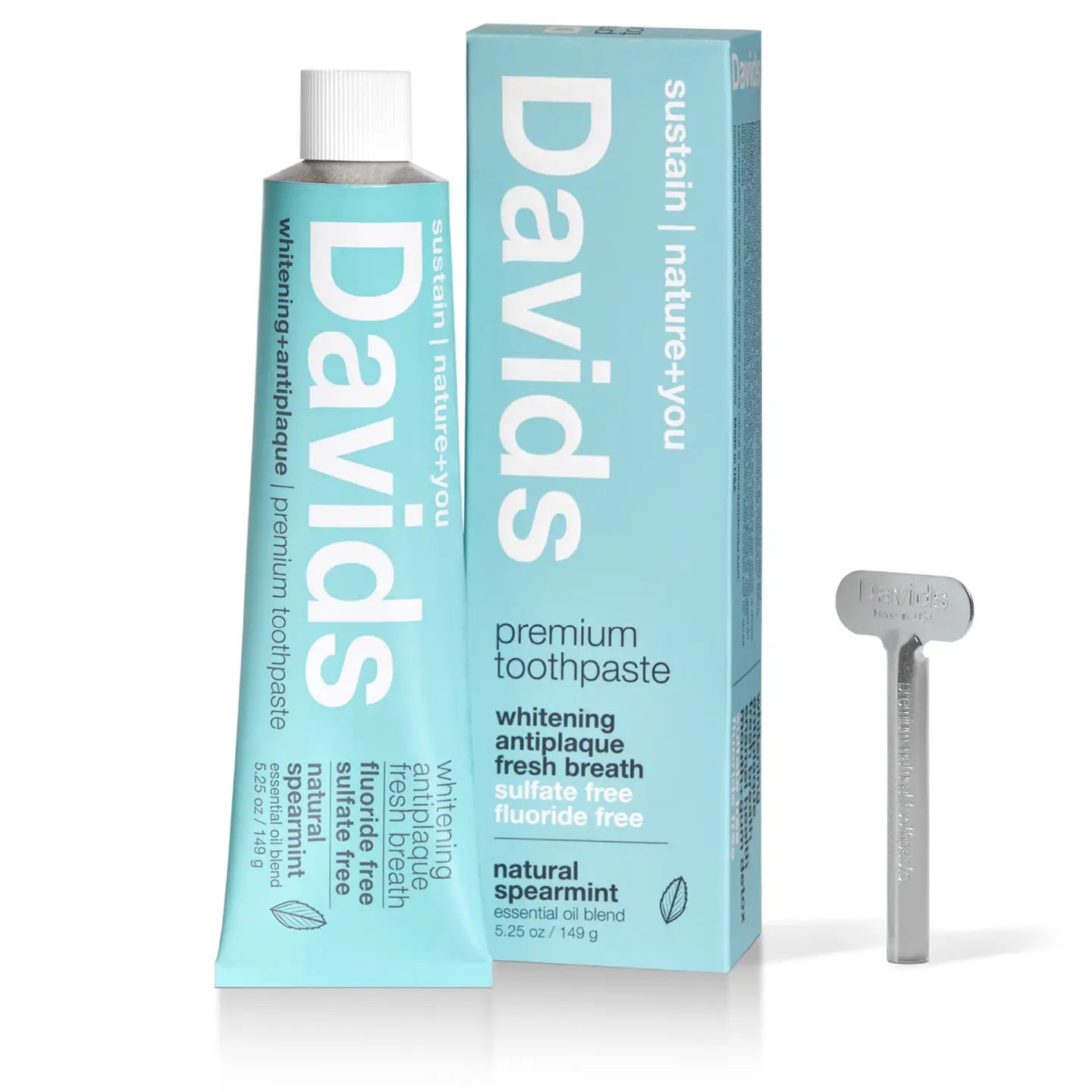 A tube of Faire Davids Toothpaste with its box and a recyclable metal tube key. The whitening, antiplaque formula is fluoride free, sulfate free, USDA certified biobased, and comes in natural spearmint flavor for fresh breath.