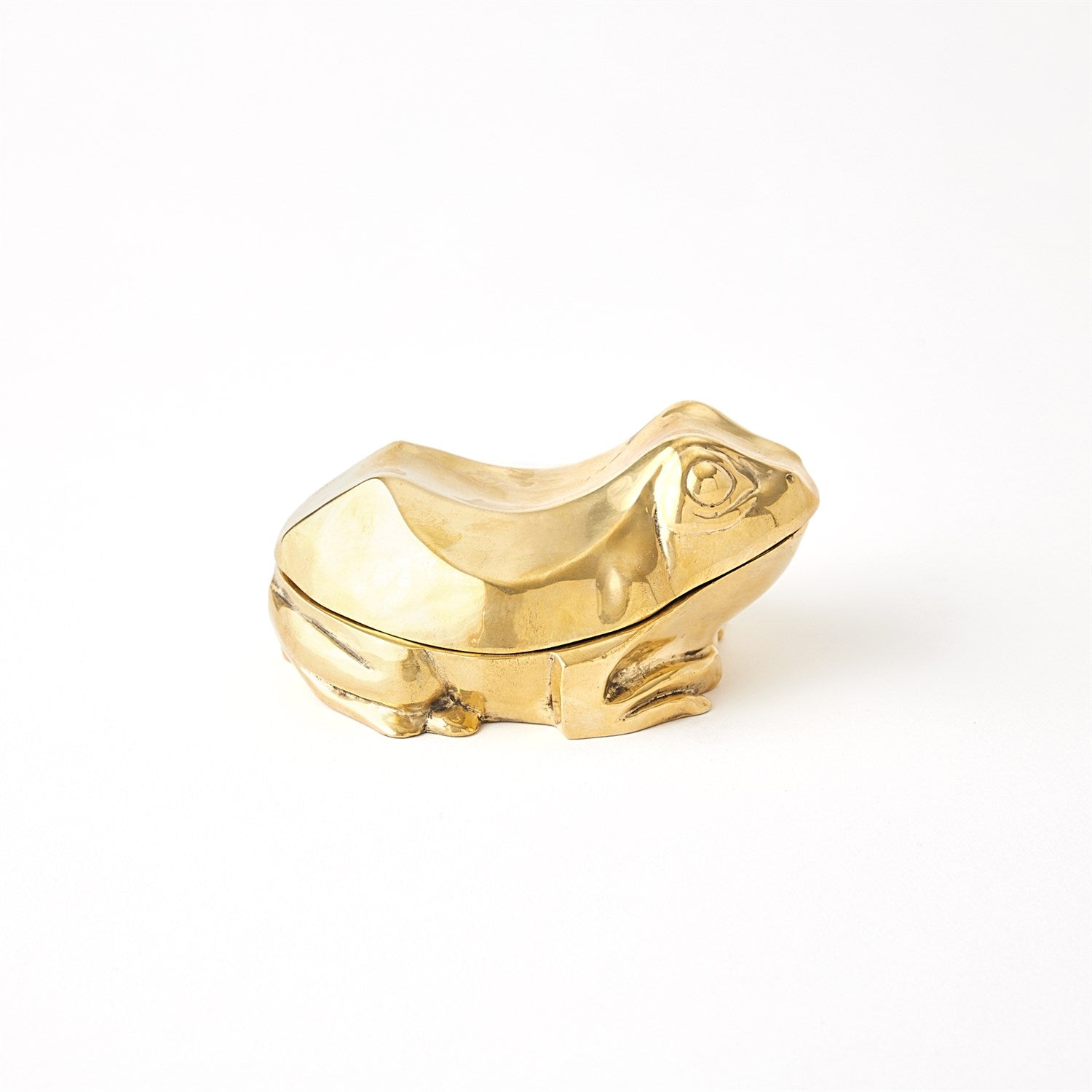 The Solid Brass Frog Box by Global Views rests gracefully on a plain white backdrop. Its sleek, polished surface gleams, with minimally detailed eyes and legs enhancing its refined finish.