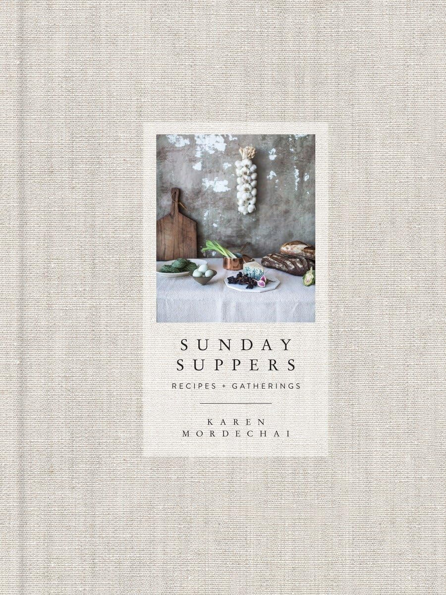 The cover of Sunday Suppers by Random House displays rustic kitchen items, bread, eggs, and garlic on a textured backdrop, perfectly mirroring the book’s seasonally inspired recipes and gatherings.