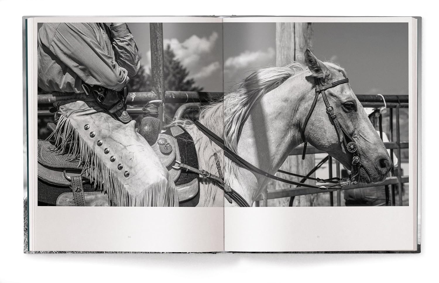 A black-and-white photo from "A Ranch Year" by Ingram Book Company captures a cowboy on horseback in fringed chaps, embodying Wyoming ranch life—an evocative piece of American West photography.