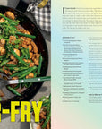A skillet of green bean and chicken stir-fry from The Choi of Cooking by Random House sits on a gray plaid towel with a serving spoon, its ingredients displayed on a yellow-green gradient background.