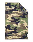 The Faire Double Sided Hand Towel features a high-absorbent waffle weave microfiber in a green, brown, black, and tan camouflage pattern. A corner is folded to show the reverse side and a small white label with text.