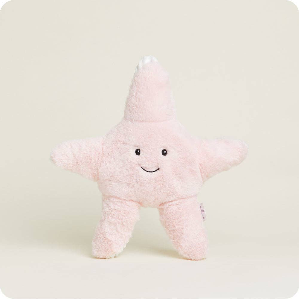 Faire’s Starfish Warmies is a soft, pink, star-shaped plush with a smiling face, centered against a plain light background—a cuddly microwavable plush for comfort and warmth.