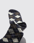 Maria La Rosa’s Harlekin Socks, expertly crafted in Italy from luxurious cashmere, feature elegant dark blue, gray, and brown argyle patterns and are displayed on a light gray background.
