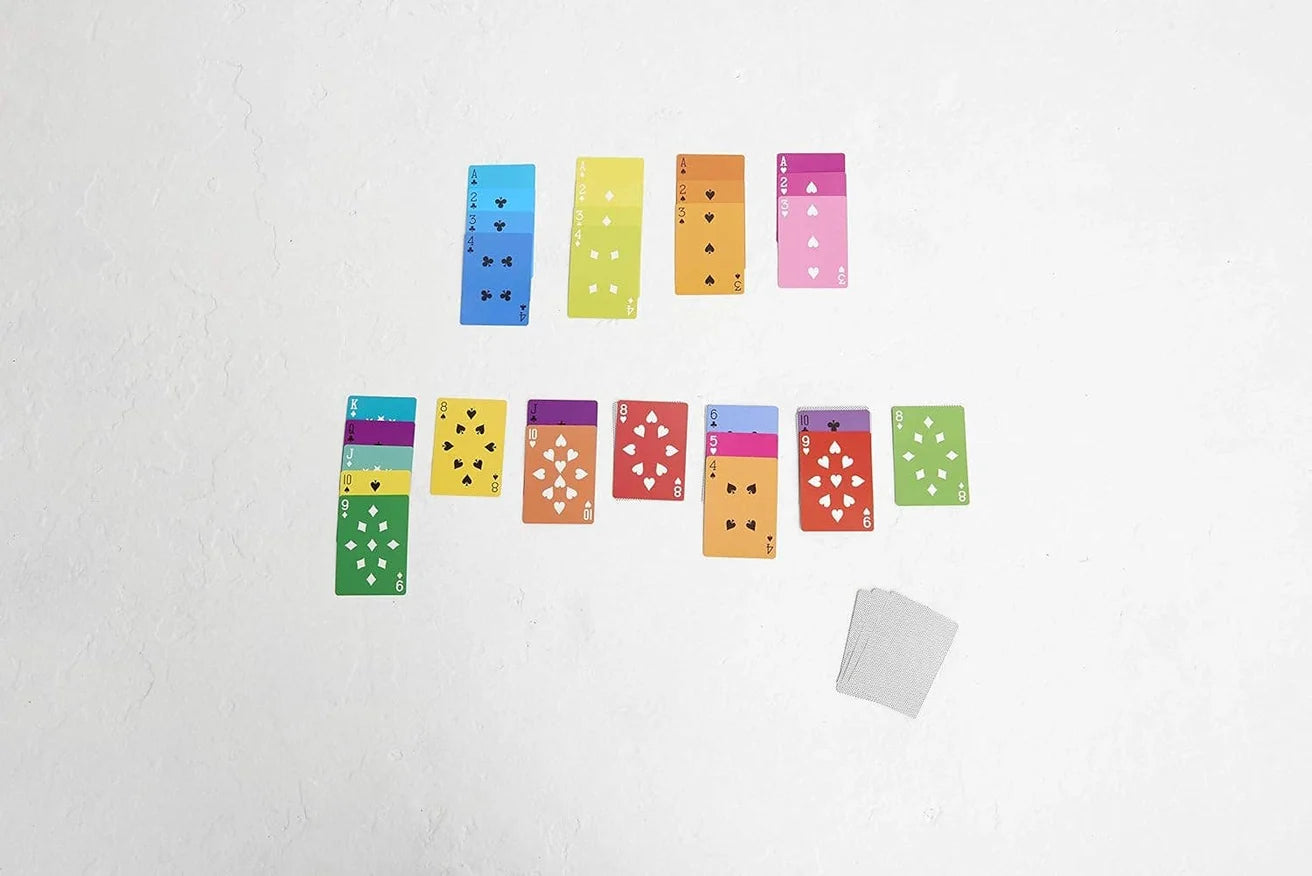 Fred Mae cards neatly arranged on a white surface, deck by Hachette Book Group sits nearby.