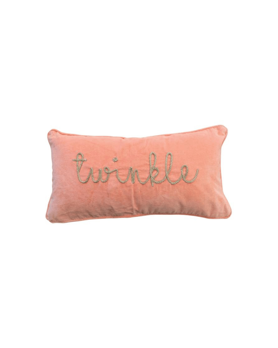 The "Twinkle" Velvet Lumbar from Creative Co-op is a rectangular, peach-colored cotton velvet pillow with the word "twinkle" embroidered in cursive with glittery, metallic gold thread on the front. The pillow boasts a soft and plush appearance.