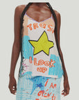 Wearing the Me369 Angelique Camisole, which features a large yellow star and "TRUST I look up" in bold letters, paired with a patterned skirt decorated with text and blue stars.