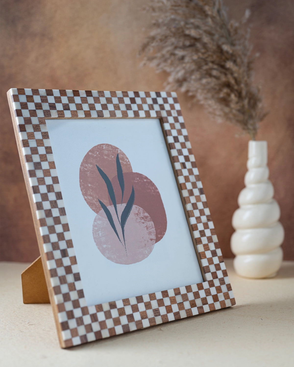 Checkered bone and wood 8x10 frame by Faire, modern accent piece for tables or shelves, ideal for any room décor.
