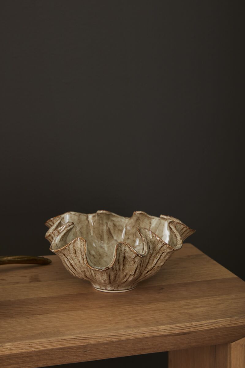 Caraway Bowl with wavy edges by Accent Decor on a wooden table, dark background, modern decorative accent.