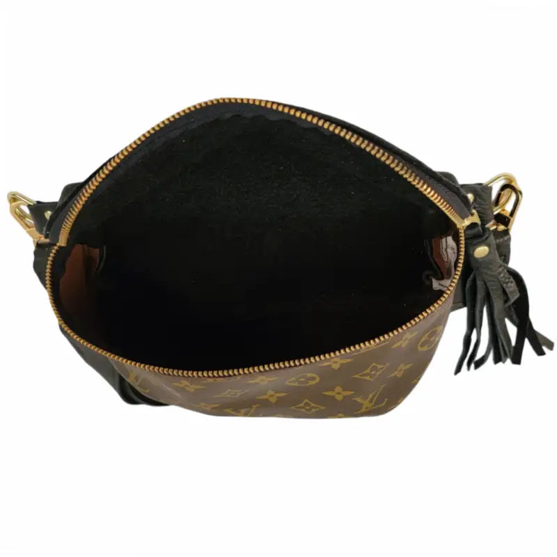 A stylish brown Upcycled Belt Bag by Faire, made of leather with a gold zipper, partially open to reveal its empty black interior, adorned with a classic monogram pattern and finished with a leather tassel.