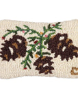 The Faire Christmas Mini Pillows are rectangular, cream-colored pillows hand hooked from natural wool, featuring three brown pinecones with green needles and red accents for a cozy, rustic look.