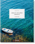 The cover of "Great Escapes Greece: The Hotel Book" from Ingram Book Company displays a small boat on a vibrant blue and green sea with vivid underwater textures, enticing readers to discover Greece's luxury hotels and rich culture.