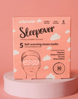 A pink box of Faire Popmask Sleepover self-warming steam masks with a rose scent offers relief for migraines, tension headaches, and dry eyes. It includes 5 unisex masks designed for 30 minutes of relaxation.