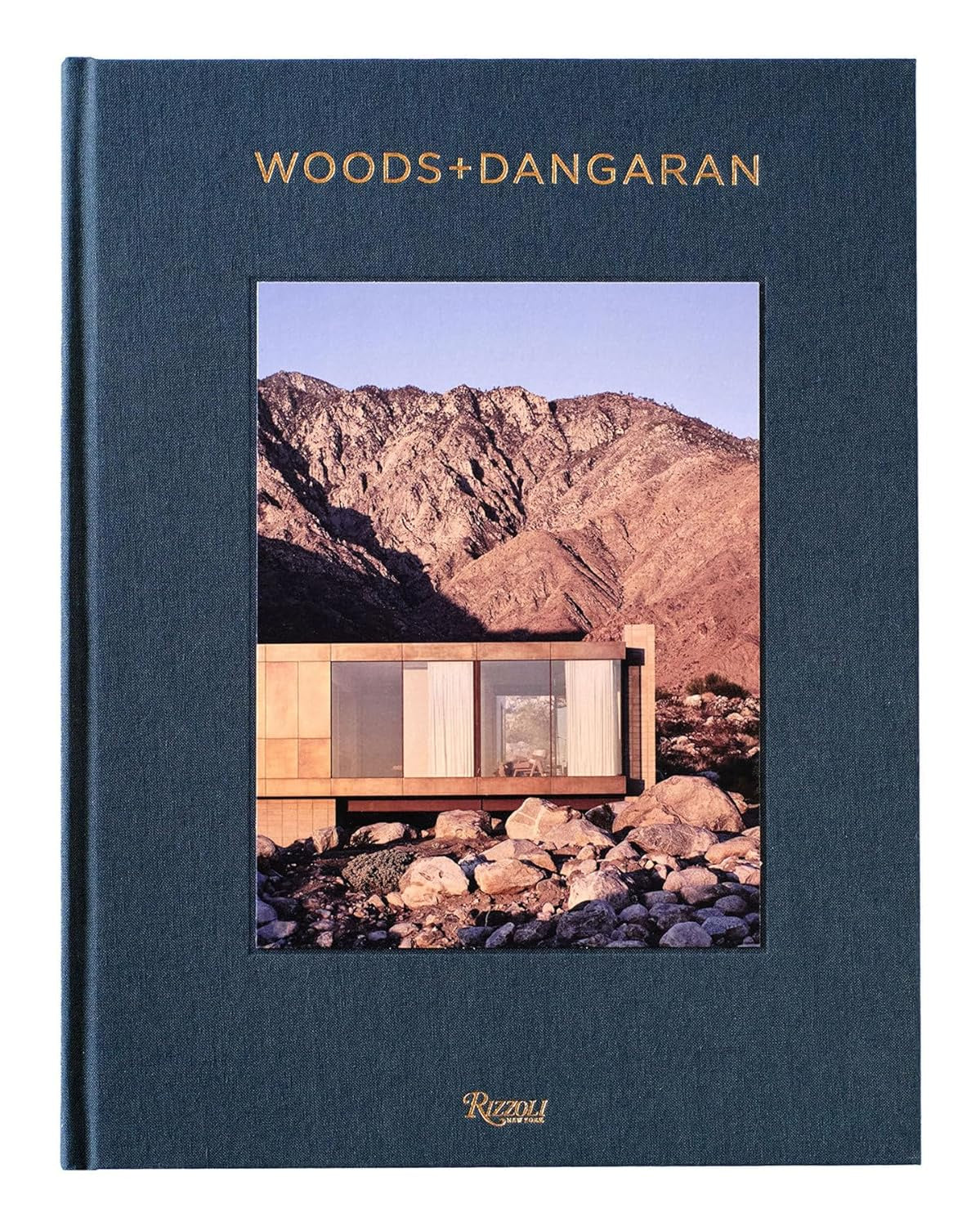 The "Woods + Dangaran" cover from Random House features a modernist home in rocky terrain surrounded by majestic mountains under a clear blue sky. Its minimalist design and large windows capture California living while honoring midcentury modernism.