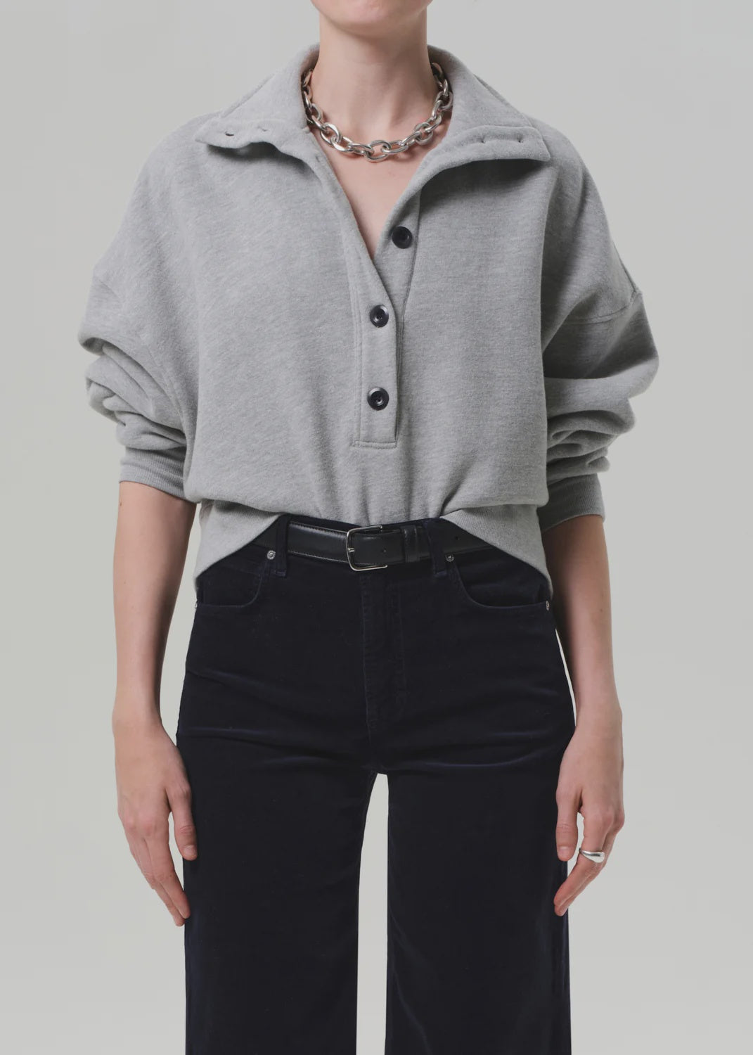 Heather grey Mirelle Funnel Neck sweater by Citizens of Humanity, styled with black pants and silver accessories.