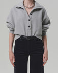 Heather grey Mirelle Funnel Neck sweater by Citizens of Humanity, styled with black pants and silver accessories.
